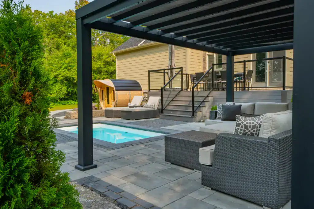 Luxurious outdoor pool area with stylish seating, private sauna, and modern landscaping details.