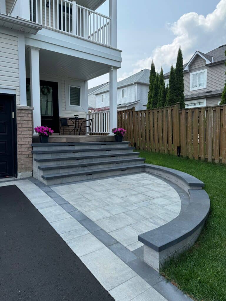 Elegant stone patio featuring stairs and a curved seating area, ideal for outdoor entertaining and enhancing curb appeal.