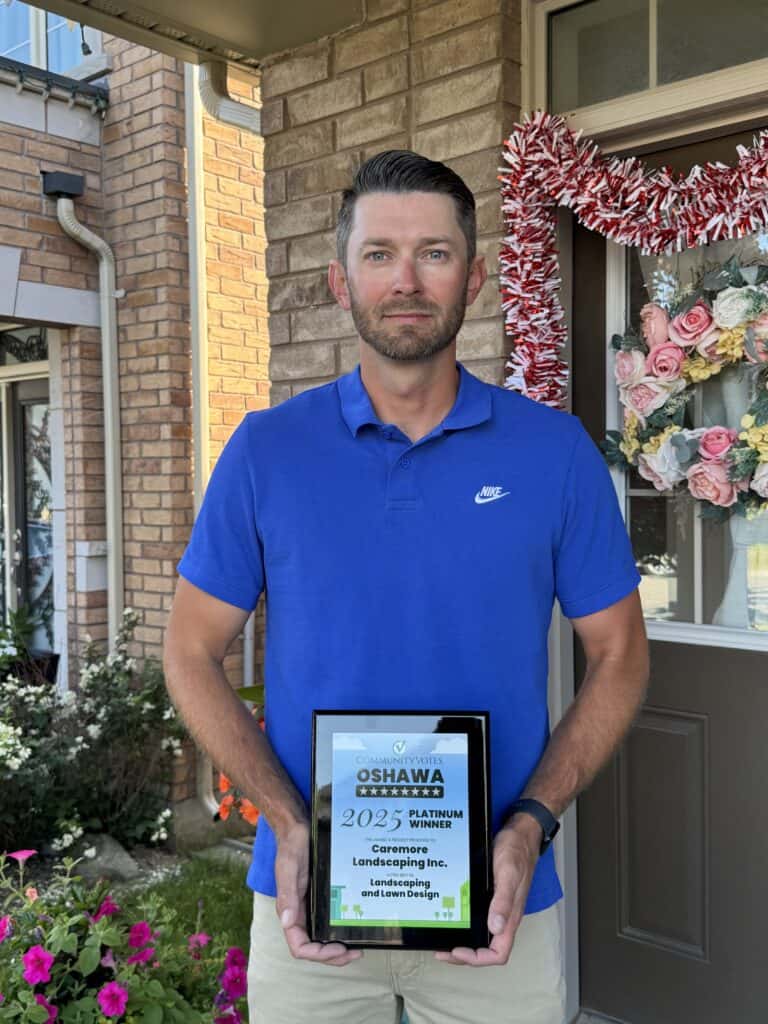 Experienced lawn care professional displaying landscaping award.