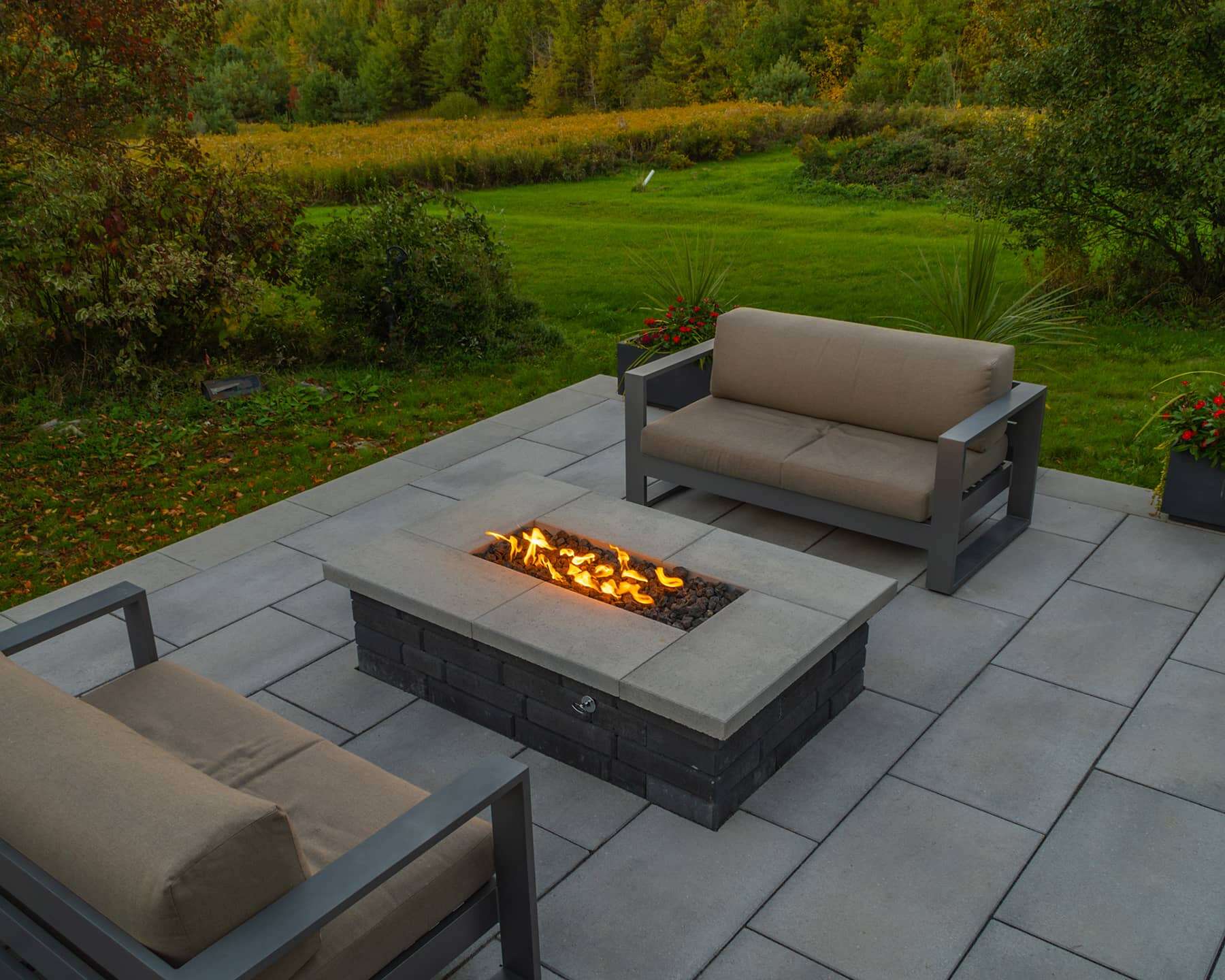 Beautiful backyard with modern fire pit, outdoor seating, and vibrant garden landscape.